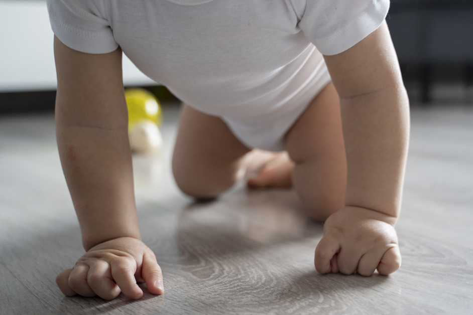 low angle cute baby crawling floor 1